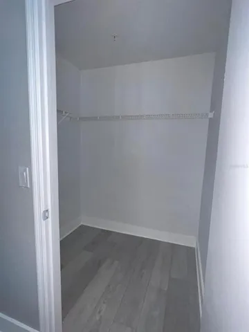 a view of bathroom with sink mirror and wooden floor