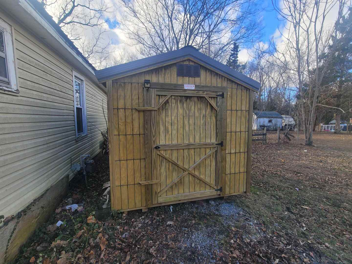 108 North Walnut Street McLeansboro, IL 62859 - Photo 24 of 25 a small barn with a small yard and wooden fence