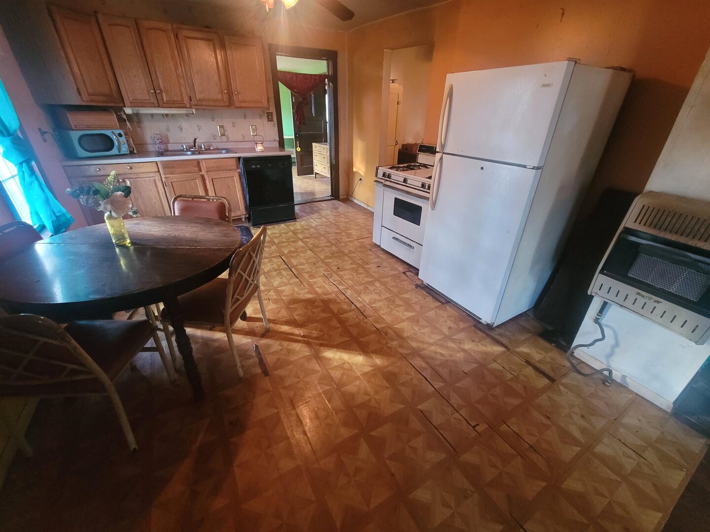 108 North Walnut Street McLeansboro, IL 62859 - Photo 8 of 25 a kitchen with refrigerator and chairs