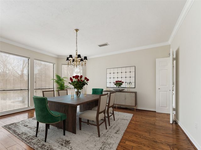 a dining room with furniture a rug and a chandelier