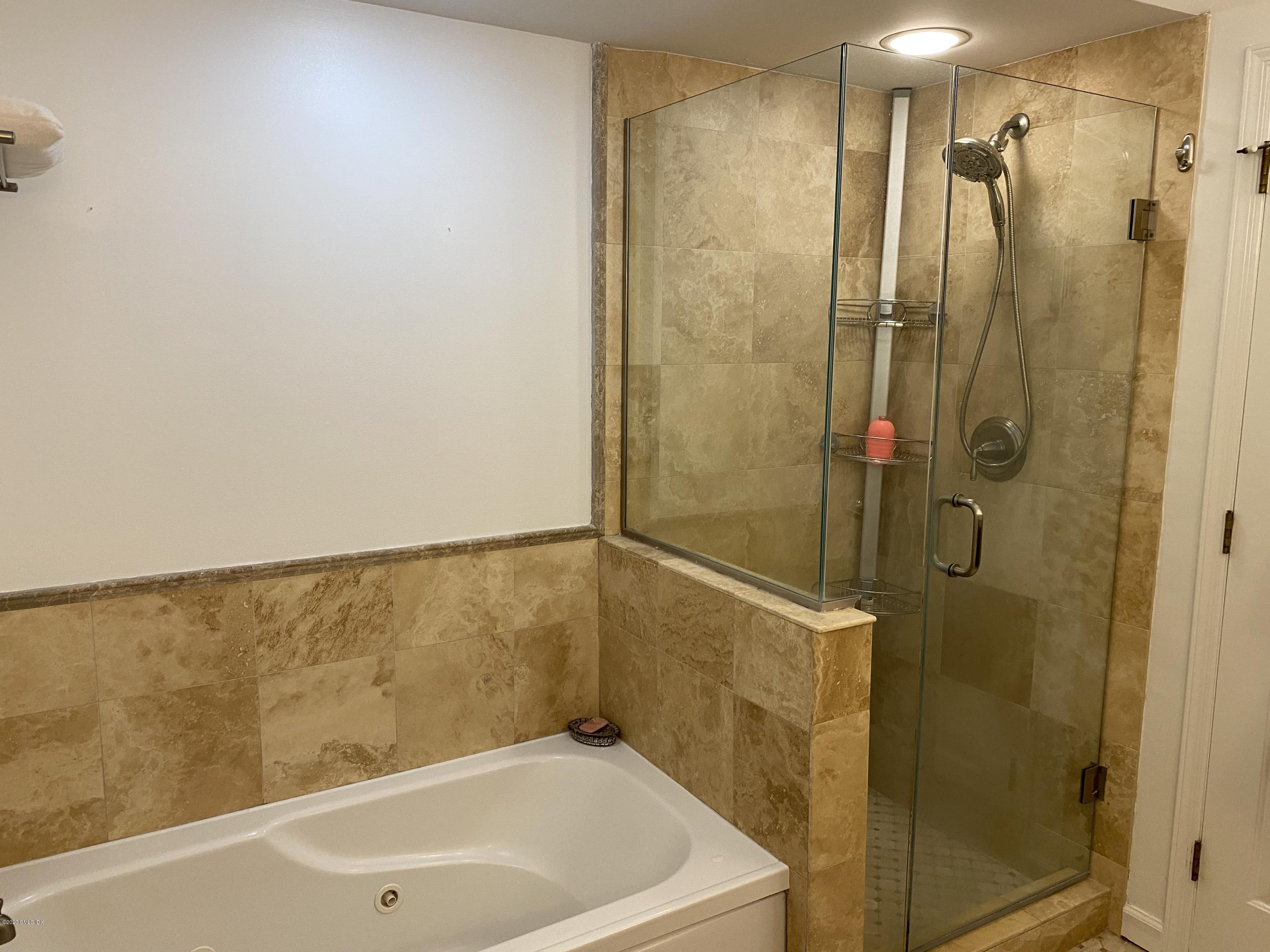 351 Pemberwick Road, Unit 607 Greenwich, CT 06831 - Photo 11 of 21 a bathroom with a bathtub and shower