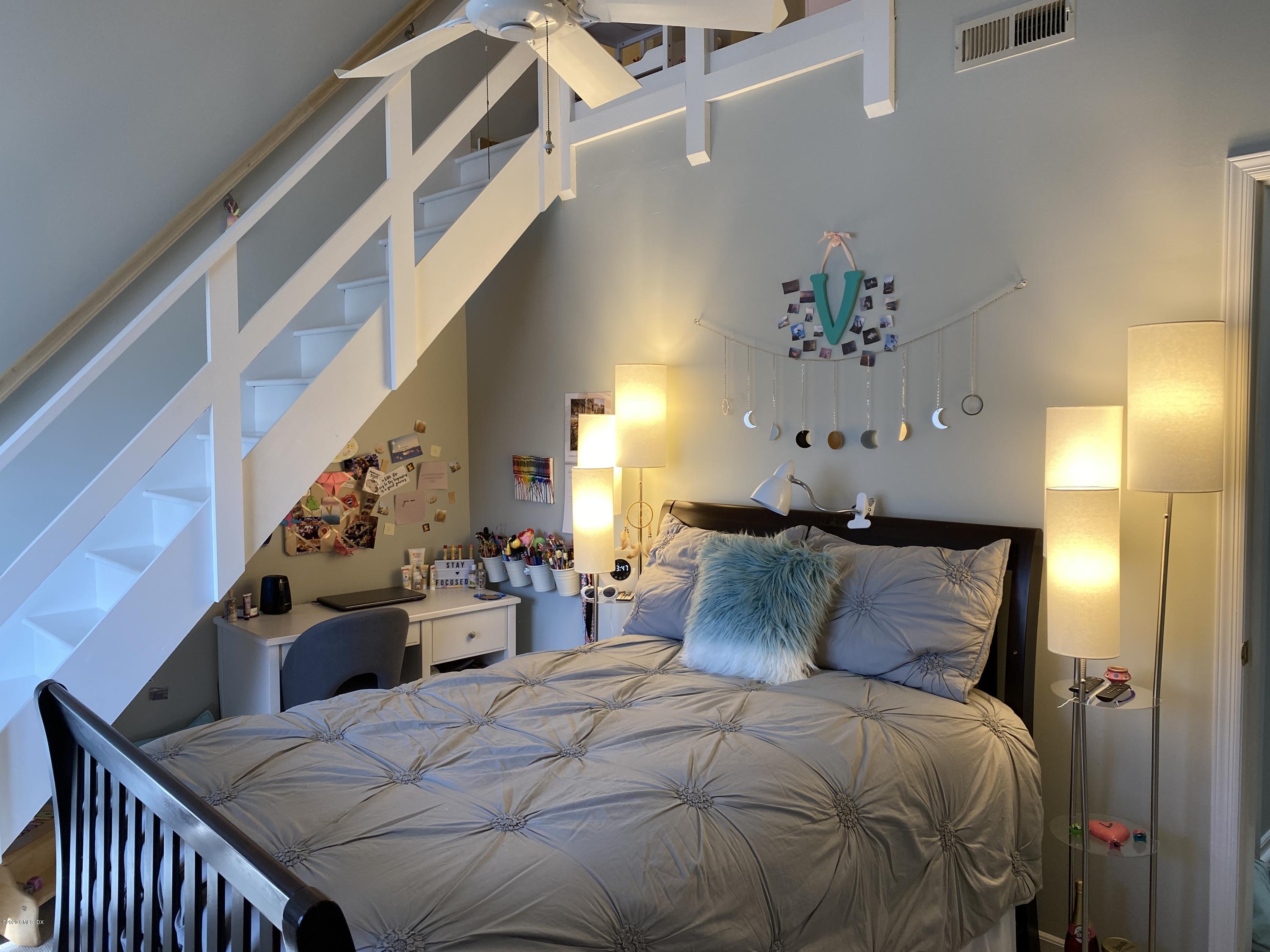 351 Pemberwick Road, Unit 607 Greenwich, CT 06831 - Photo 13 of 21 a bedroom with a bed and wooden floor