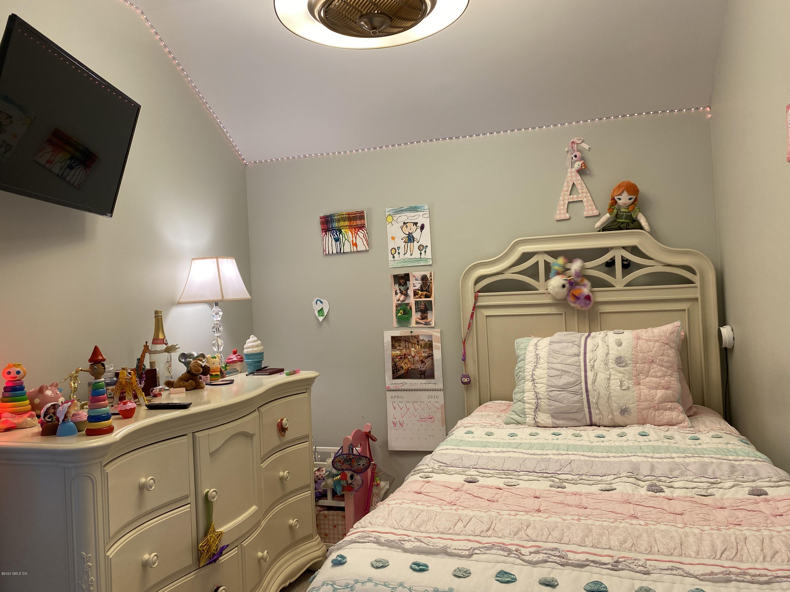 351 Pemberwick Road, Unit 607 Greenwich, CT 06831 - Photo 14 of 21 a bedroom with a bed and a flat tv screen on the dresser