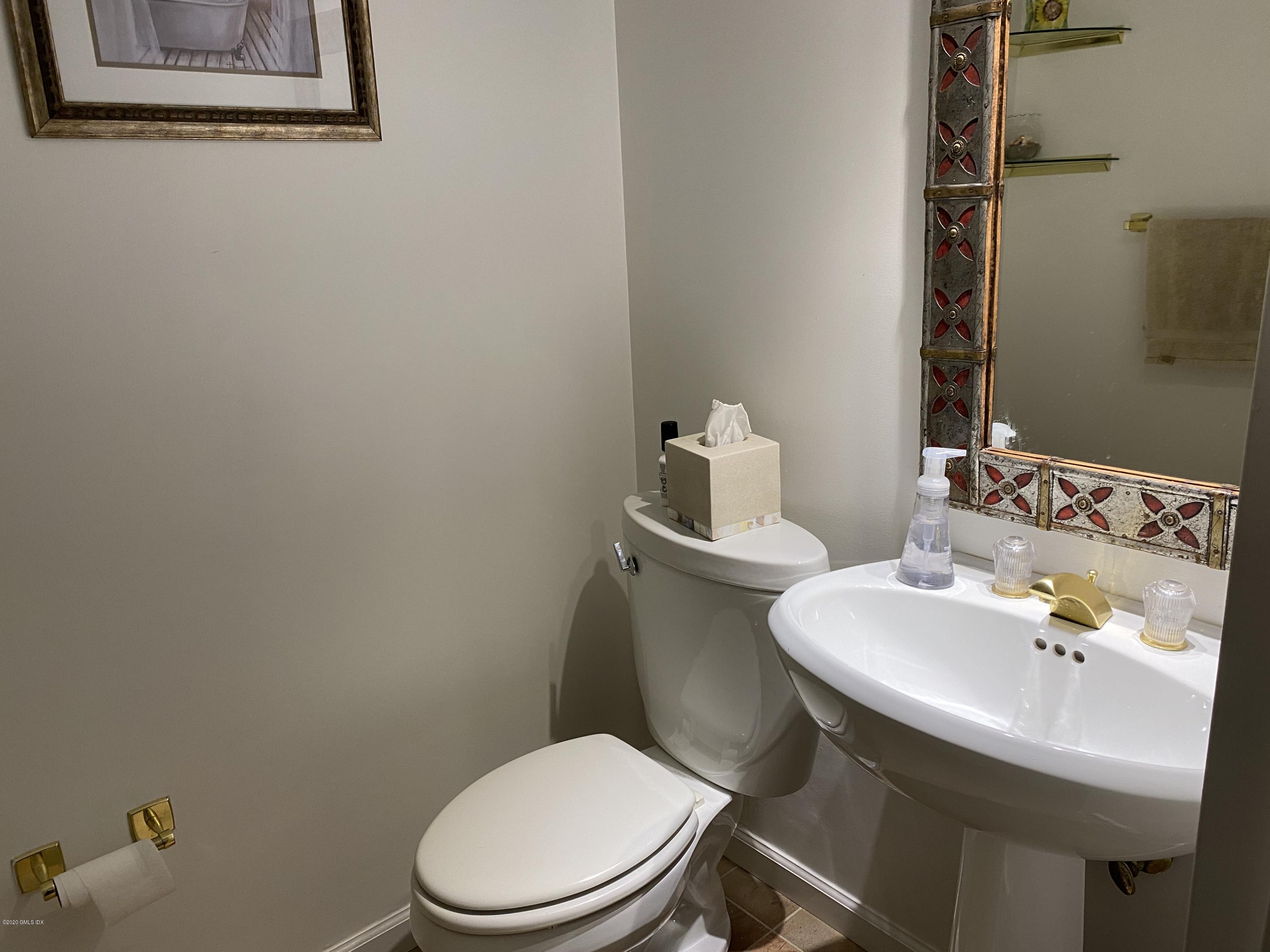 351 Pemberwick Road, Unit 607 Greenwich, CT 06831 - Photo 16 of 21 a white toilet sitting next to a bathroom sink