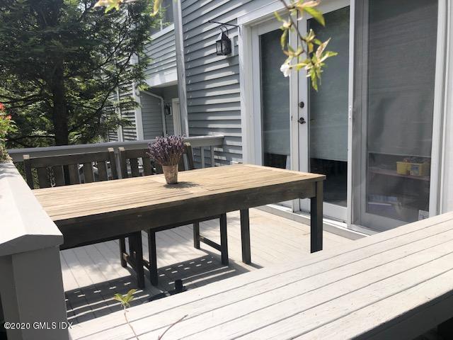 351 Pemberwick Road, Unit 607 Greenwich, CT 06831 - Photo 18 of 21 a view of a balcony with a table and chairs