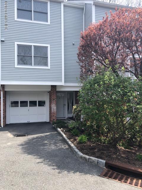 351 Pemberwick Road, Unit 607 Greenwich, CT 06831 - Photo 21 of 21 a front view of a house with a yard