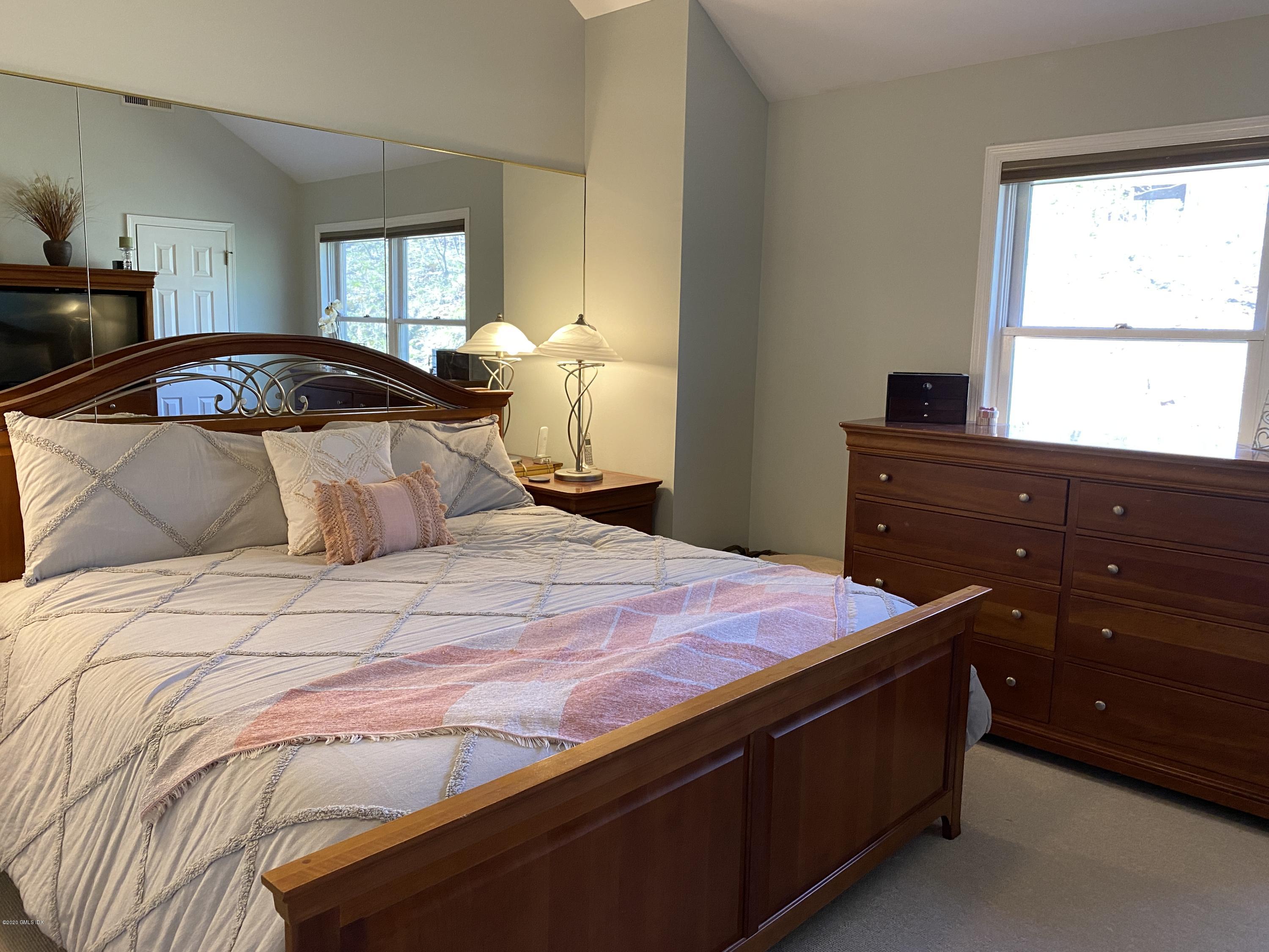 351 Pemberwick Road, Unit 607 Greenwich, CT 06831 - Photo 8 of 21 a bedroom with a bed and a window