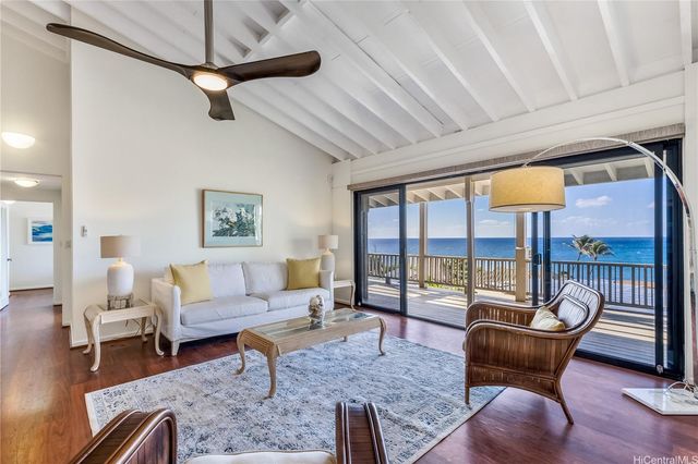 a living room with furniture and a floor to ceiling window