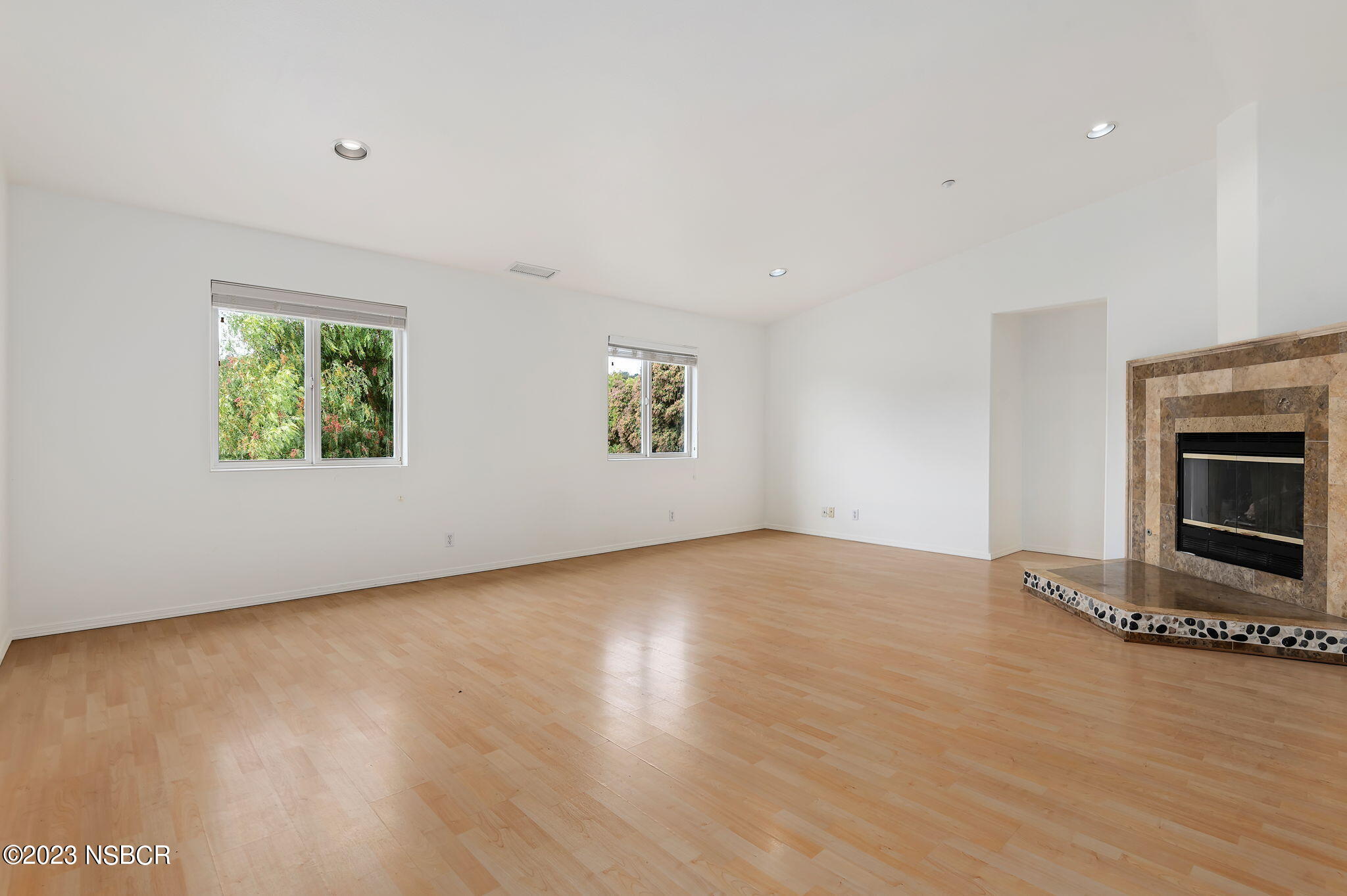 1180 Alamo Pintado Road Solvang, CA 93463 - Photo 9 of 20 an empty room with windows and fireplace