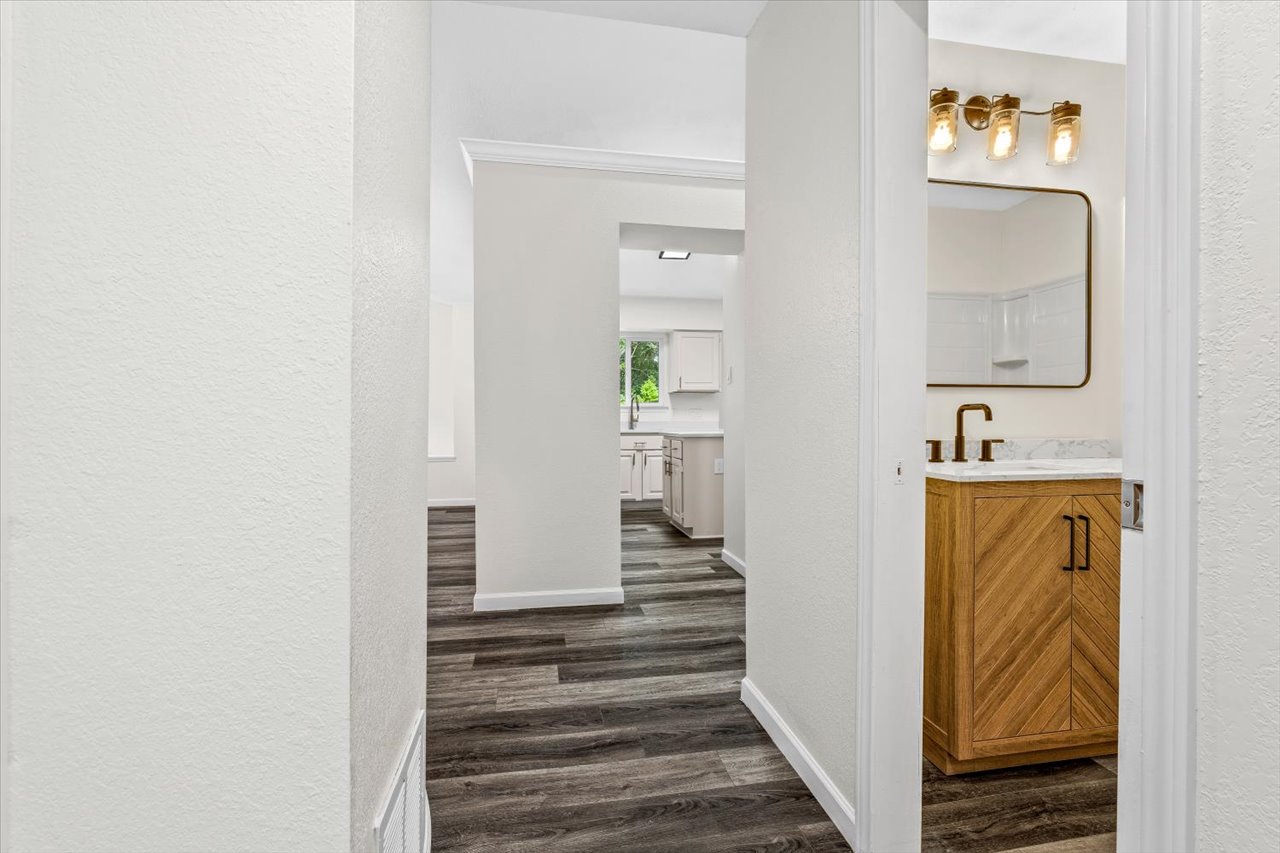 4004 Danli Lane Austin, TX 78749 - Photo 14 of 40 a view of a hallway with wooden floor and a bathroom
