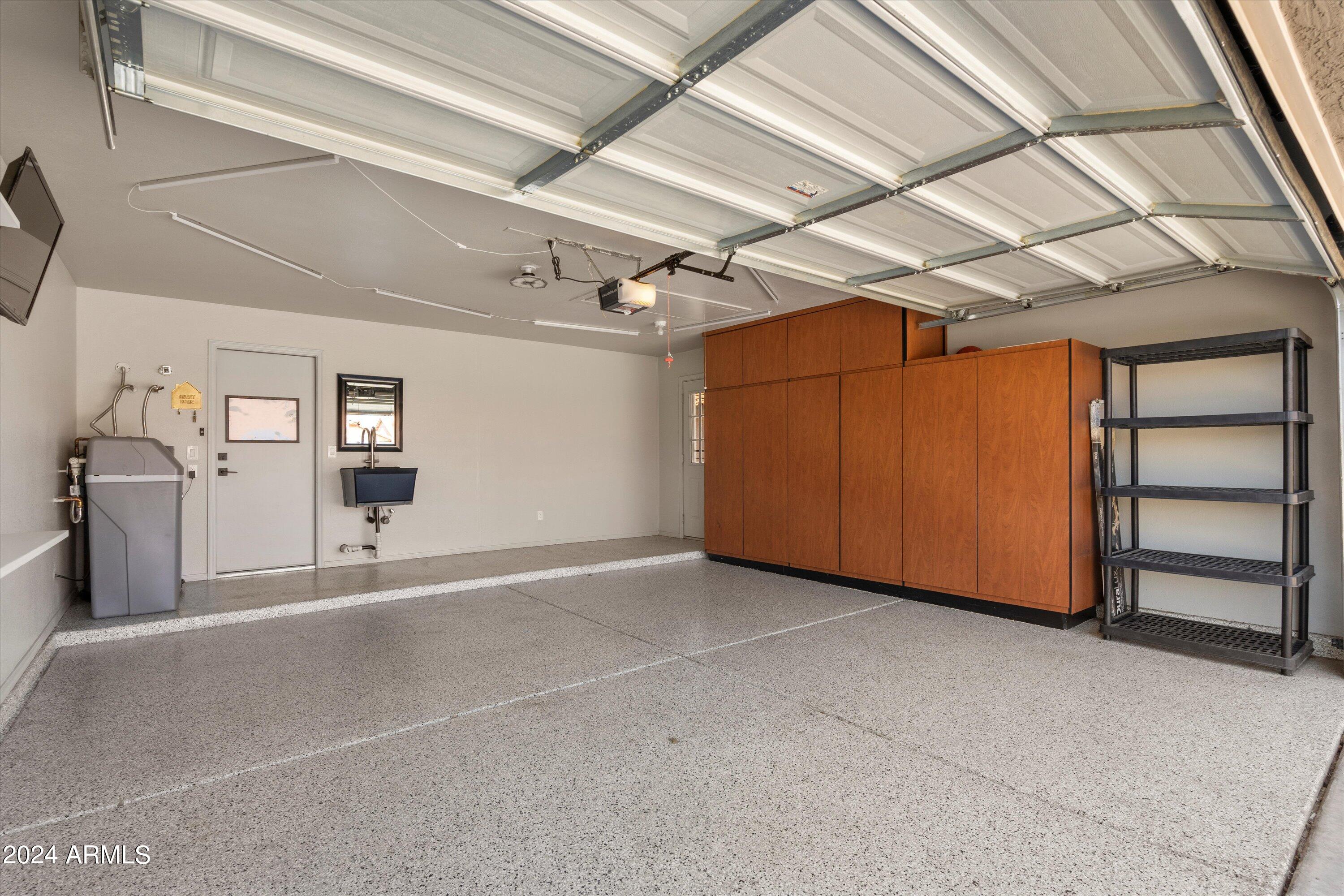 7709 West Boca Raton Road Peoria, AZ 85381 - Photo 41 of 45 Garage epoxy floor and built ins