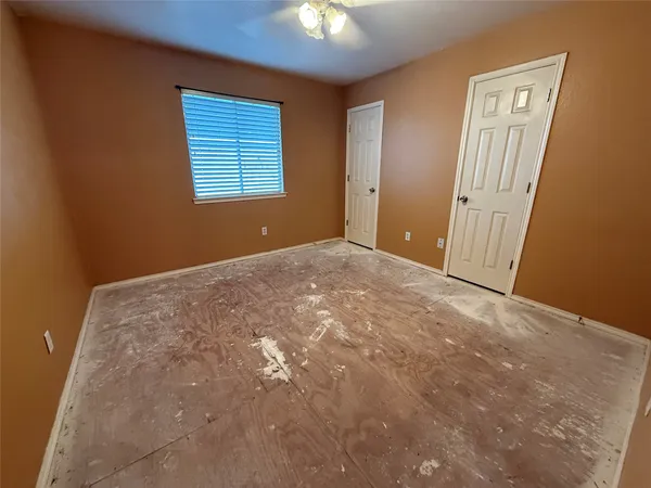 an empty room with windows and closet