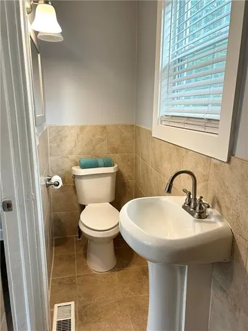 a bathroom with a sink a toilet and a mirror