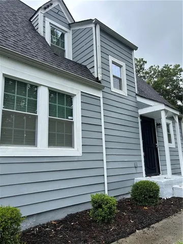 a view of a house with a backyard