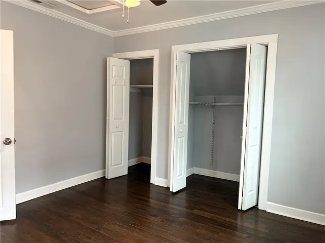 an empty room with wooden floor and closet