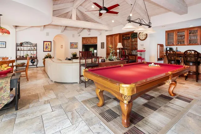 a spacious bedroom with a bed a couch and a fireplace