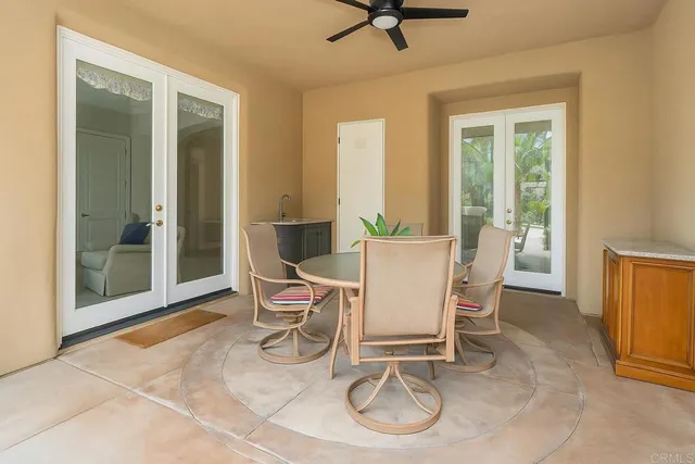 a view of a house with sitting area and swimming pool