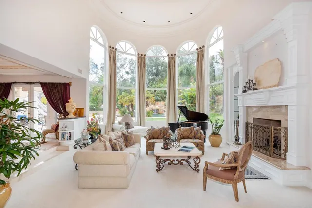 a living room with furniture a flat screen tv and a dining table