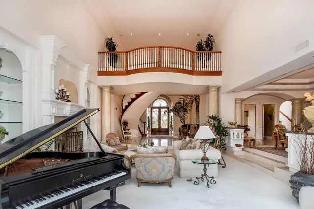 a large bed sitting in a bedroom next to a window