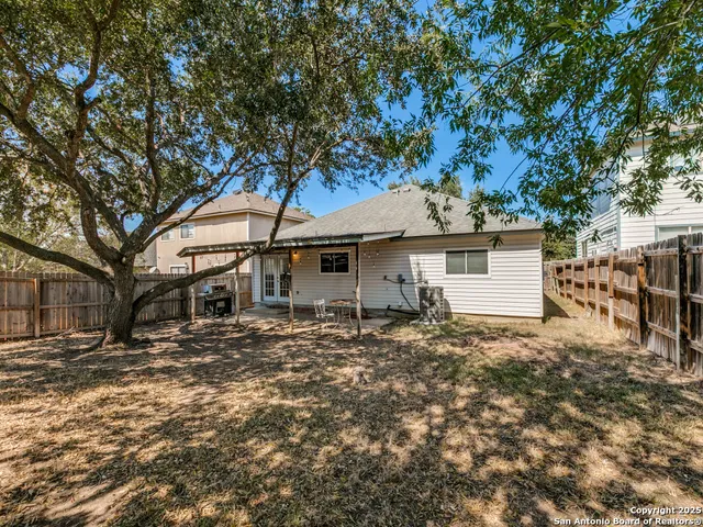 a white house that has a tree in front of it