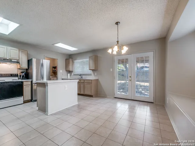 a kitchen with a refrigerator a stove a microwave and cabinets