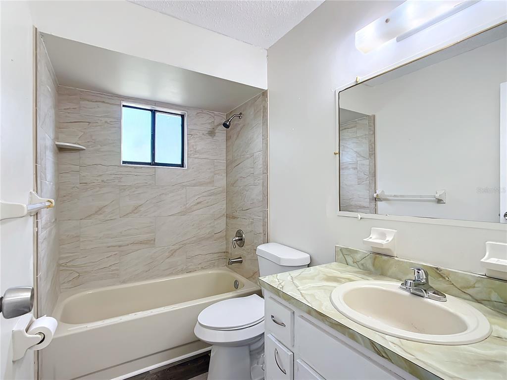 8917 Southwest 104th Place Ocala, FL 34481 - Photo 20 of 41 a bathroom with a sink toilet tub and shower