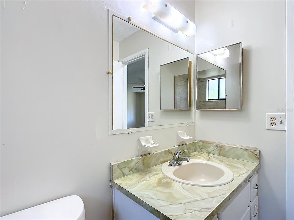 8917 Southwest 104th Place Ocala, FL 34481 - Photo 21 of 41 a bathroom with a granite countertop sink and a mirror
