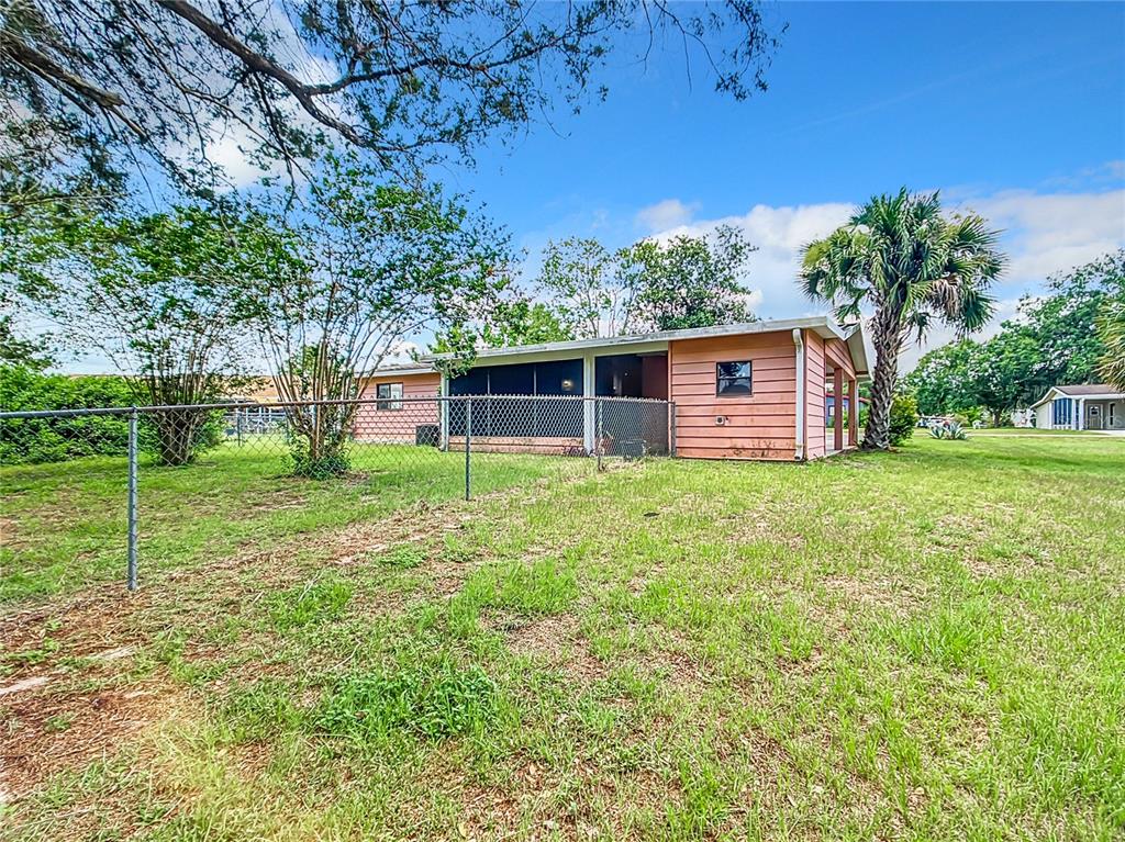 8917 Southwest 104th Place Ocala, FL 34481 - Photo 40 of 41 a view of a house with backyard and a tree