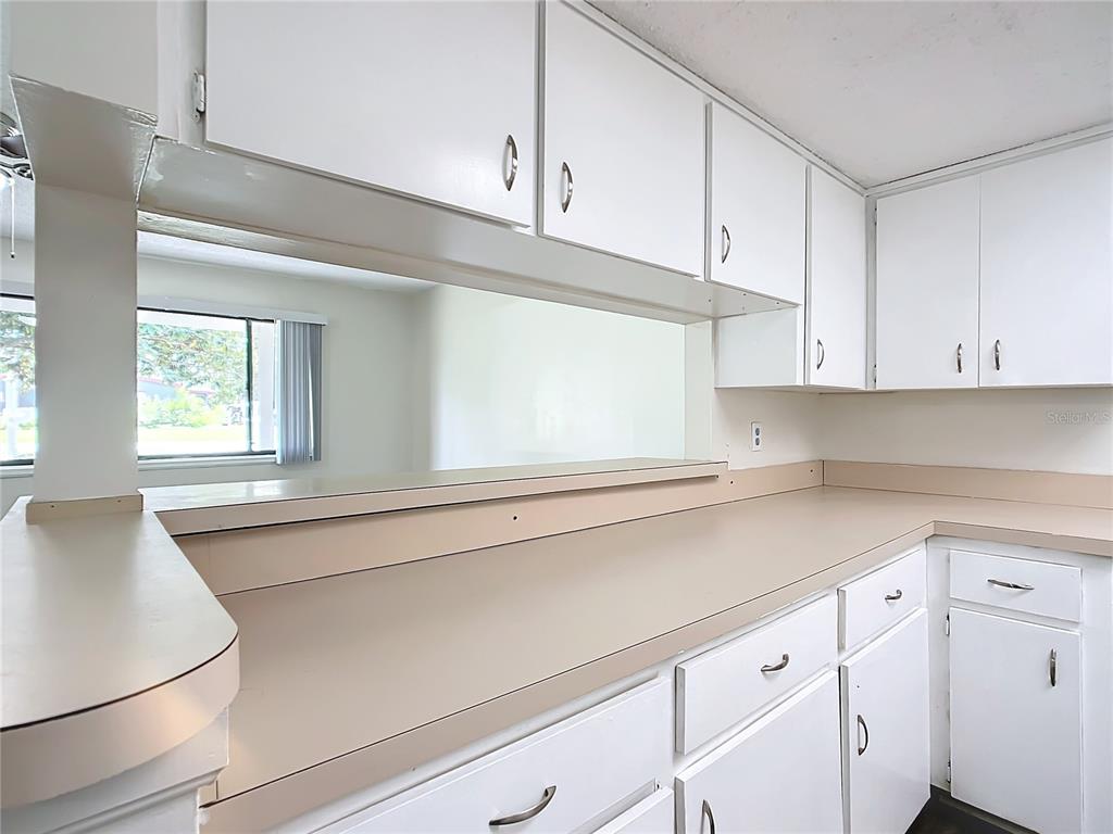8917 Southwest 104th Place Ocala, FL 34481 - Photo 6 of 41 a kitchen with granite countertop white cabinets and white appliances
