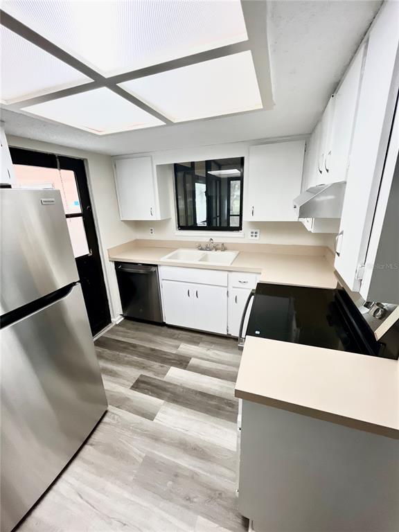 8917 Southwest 104th Place Ocala, FL 34481 - Photo 7 of 41 a kitchen with a sink a refrigerator and cabinets