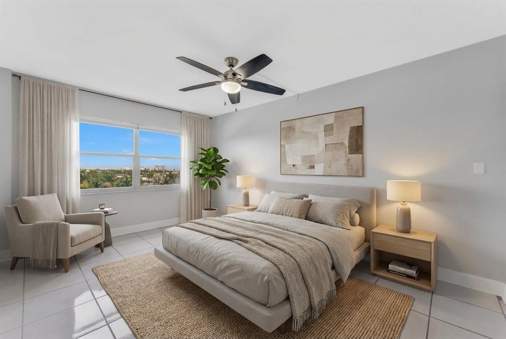 2555 Northeast 11th Street, Unit 708 Fort Lauderdale, FL 33304 - Photo 12 of 17 a bedroom with a large bed and a couch