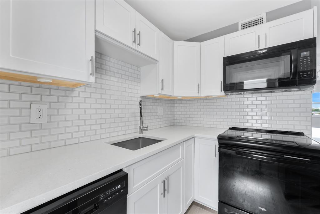 2555 Northeast 11th Street, Unit 708 Fort Lauderdale, FL 33304 - Photo 3 of 17 a kitchen with a sink appliances and cabinets