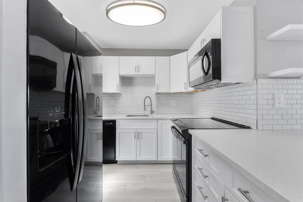 2555 Northeast 11th Street, Unit 708 Fort Lauderdale, FL 33304 - Photo 4 of 17 a kitchen with a sink and a refrigerator