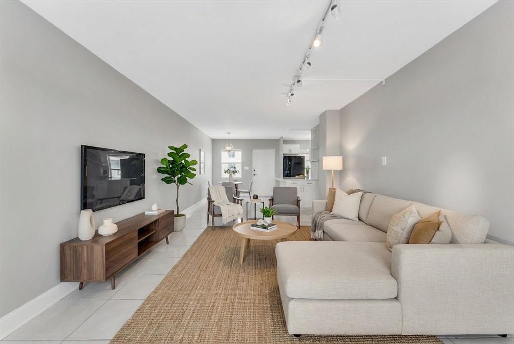 2555 Northeast 11th Street, Unit 708 Fort Lauderdale, FL 33304 - Photo 5 of 17 a living room with furniture and a flat screen tv