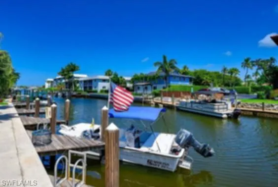 a view of a lake with couches chairs