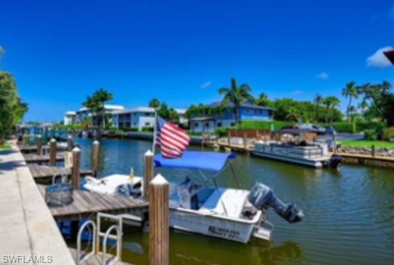 a view of a lake with couches chairs