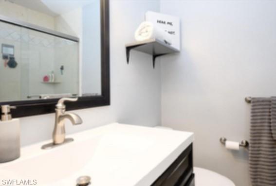 1369 Chesapeake Avenue, Unit B5 Naples, FL 34102 - Photo 11 of 15 a bathroom with a sink vanity and toilet