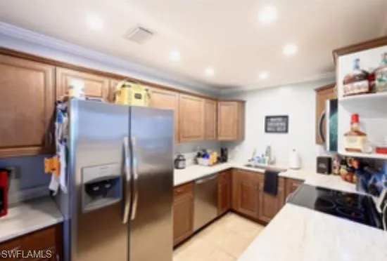 a kitchen with stainless steel appliances a refrigerator sink and cabinets