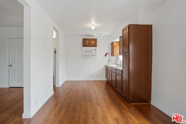 a view of hallway with wooden floor