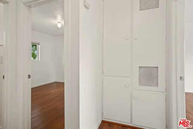 a view of hallway with wooden floor