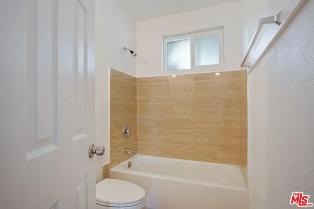 a bathroom with a toilet and a bathtub