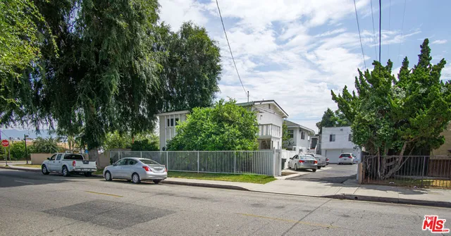 a front view of a house with parking space