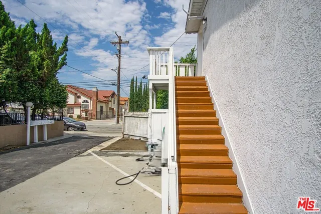 a view of a patio with a table and chairs