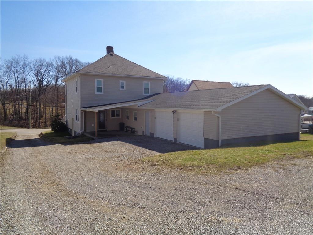 991 Main Street Rimersburg, PA 16248 - Photo 6 of 36 a front view of a house with a yard and garage