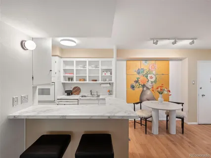 a view of a dining room with furniture and wooden floor