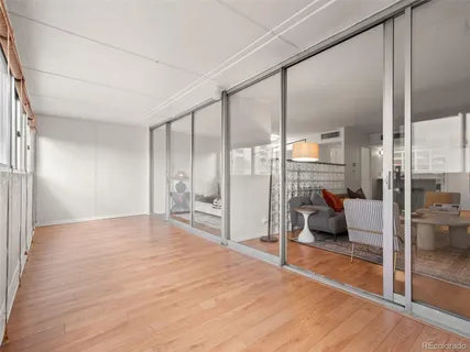 a bedroom with a bed and large window
