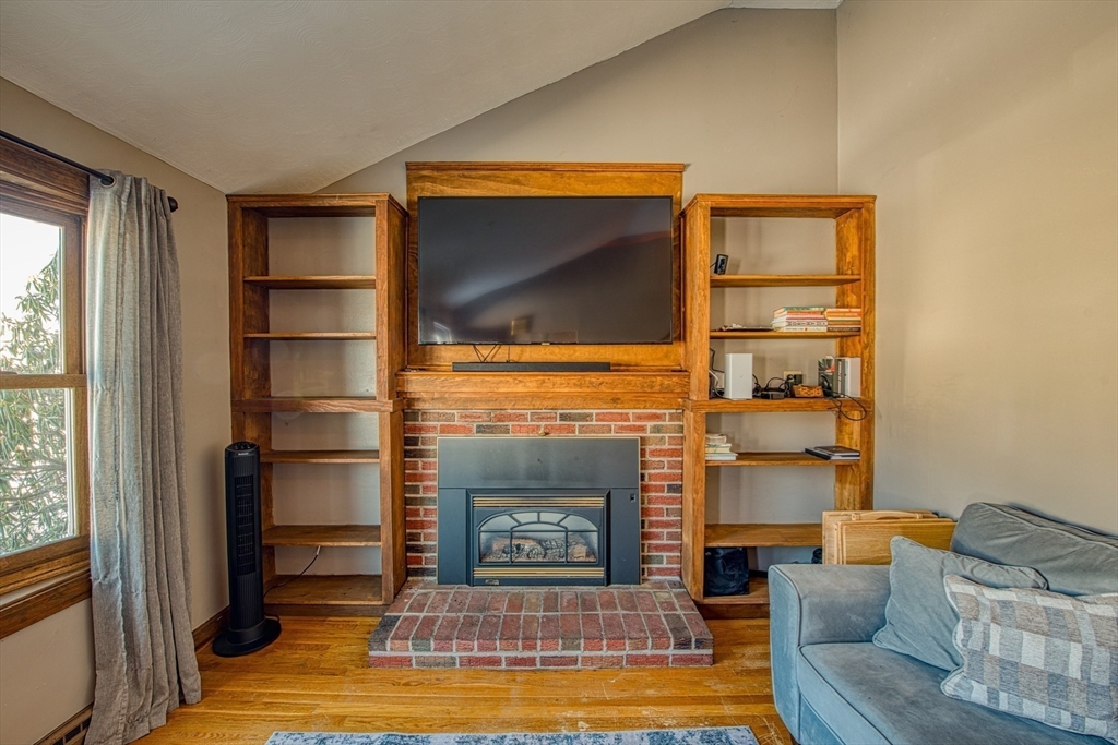 12 Brewster Road Randolph, MA 02368 - Photo 5 of 27 a living room with furniture and a fireplace