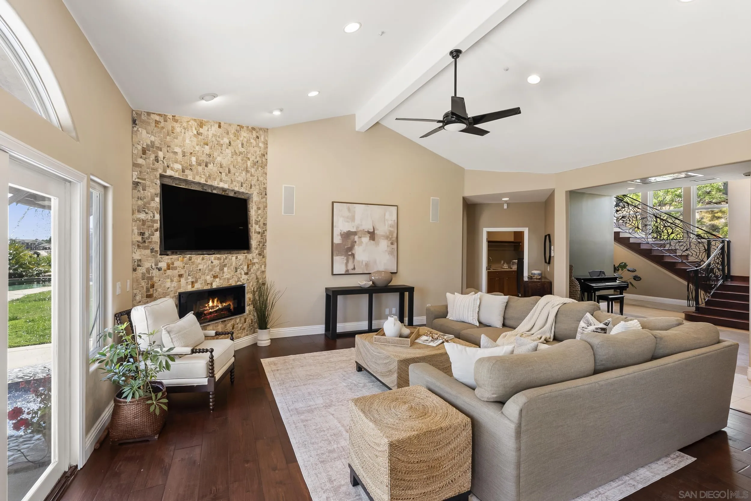 14998 Budwin Lane Poway, CA 92064 - Photo 28 of 44 a living room with furniture a fireplace and a flat screen tv