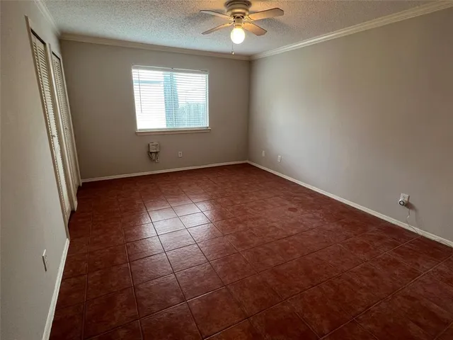 en empty room with windows and fan