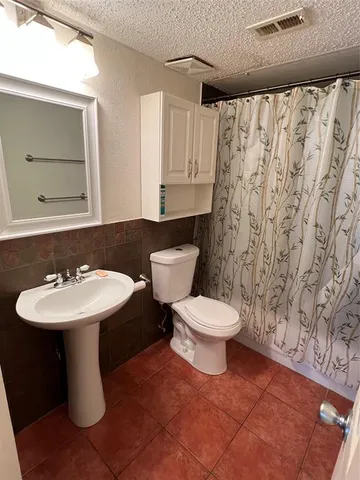 a bathroom with a sink toilet and mirror